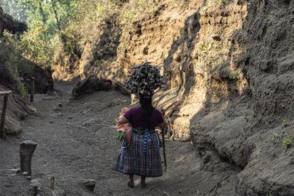 A woman carries firewood on her head in Guatemala.