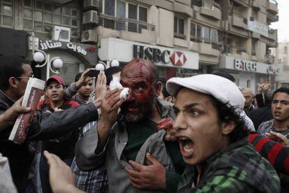Un presunto miembro de la Hermandad Musulmana es arrastrado por una multitud de manifestantes después de haber sido golpeado en la cabeza durante los enfrentamientos.