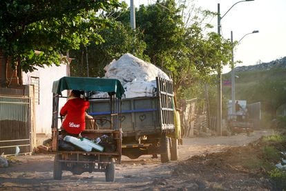 Informal trucks collect and move garbage in the capital of Paraguay.