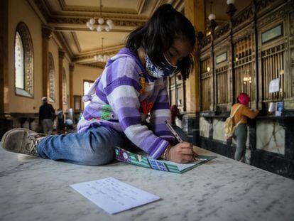 Una niña escribe su carta dirigida a los Reyes Magos a las oficinas de Correos de México.