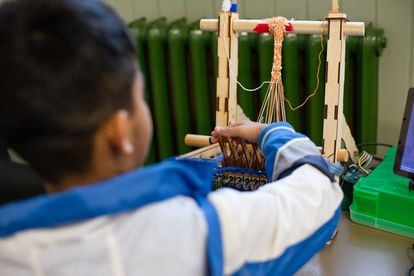 A child operates the loom during one of the workshops