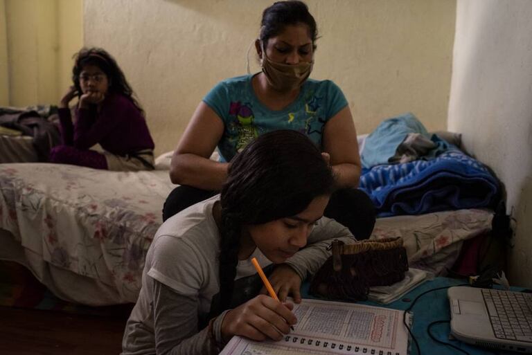 Dayanira Blanco y su hija Sara hacen las tareas que su maestra le envía semanalmente por WhatsApp durante el confinamiento en Ecuador.