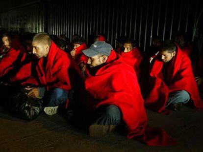 Los inmigrantes interceptados el viernes en el Estrecho se calientan con mantas de la Cruz Roja.