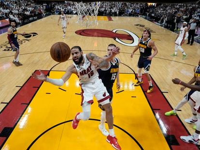 El alero del Miami Heat, Caleb Martin, pierde el control del balón cuando se dirige a la canasta contra  Nikola Jokic, de los Denver Nuggets, durante la primera mitad del Juego 4 de las Finales de la NBA.