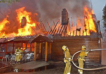Los bomberos tratan de extinguir el fuego en una casa de Lake Arrowhead, en California.