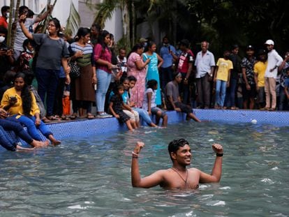 A man stands in the swimming pool as people visit the President's house on the day after demonstrators entered the building, after President Gotabaya Rajapaksa fled, amid the country's economic crisis, in Colombo, Sri Lanka July 10, 2022. REUTERS/Dinuka Liyanawatte