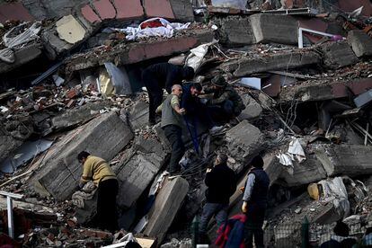 Familias buscan a desaparecidos entre los escombros de un edificio colapsado en Kahramanmaras (Turquía). 