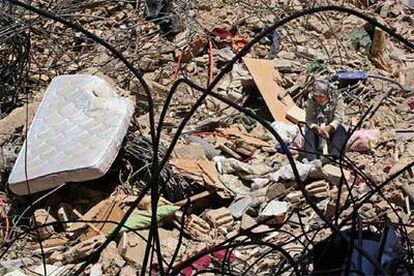 Una mujer, sentada en medio de los escombros de viviendas en un suburbio de Beirut.