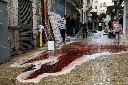 Cleaning the pavement after the shooting in the Old City of Jerusalem this Sunday.