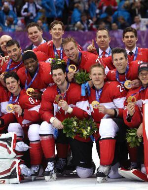 El equipo masculino de hockey canadiense posa con la medalla de oro