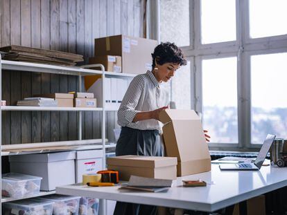 A Smart Businesswoman Preparing Packages For Shipping In Her Store