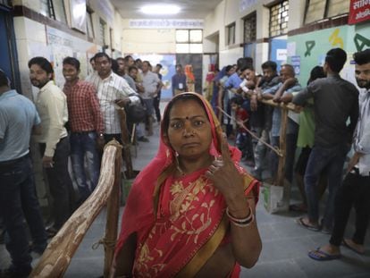 Una mujer muestra una marca indeleble en su dedo tras votar en Nueva Delhi, India el 12 de mayo de 2019.