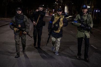 Gennadi Raskin, first from left, with Alexander, third from left, whose father is also Jewish, and members of other denominations of the Territorial Defense Forces during a night patrol through downtown Odessa.