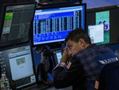 Un trader, enfundado en su elegante chaqueta, descansa la vista despu&eacute;s del toque de campana en Wall Street.
