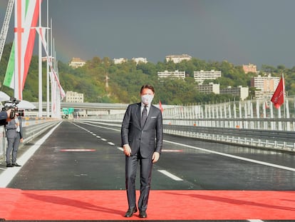 Italian Premier Giuseppe Conte walks along the new San Giorgio Bridge in Genoa, Italy, Monday, Aug. 3, 2020. Two years ago this month, a stretch of roadbed collapsed on Genoa's Morandi Bridge, sending cars and trucks plunging to dry riverbed below and ending 43 lives. On Monday, Italy's president journeys to Genoa for a ceremony to inaugurate a replacement bridge. Designing the new span was Genoa native, Renzo Piano, a renowned architect. (Gian Mattia D'Alberto/LaPresse via AP)
