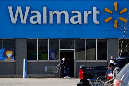 Una mujer pasa con un carro de la compra por delante de una tienda de Walmart en Illinois.