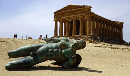 Escultura de &Iacute;caro con el templo de la Concordia de Agrigento al fondo.
