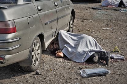 The body of a victim covered by a blanket after the attack.