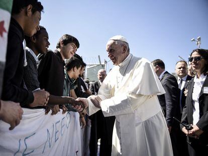 El papa Francisco saluda a migrantes y refugiados durante su visita al campo de refugiados de Moria, en la isla griega de Lesbos.