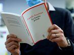 A man reads Camille Kouchner's book "La Familia Grande" in Paris on January 05, 2021. - Accused of incest on one of his step-sons in a book to be published on January 07, 2021, renowned French political scientist Olivier Duhamel announced on January 04 he would end all of his functions, including that of president of the National Political Science Foundation (FNSP). (Photo by Thomas SAMSON / AFP)