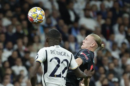   Real Madrid's German defender, Antonio Rudiger, disputes the ball against Manchester City's Norwegian forward, Erling Haaland.