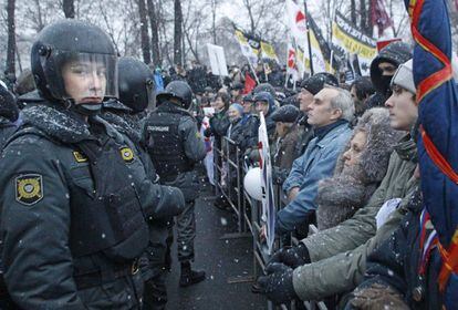 Manifestantes, encarados a policías, durante una protesta en Moscú denunciando el fraude electoral el pasado 10 de diciembre.