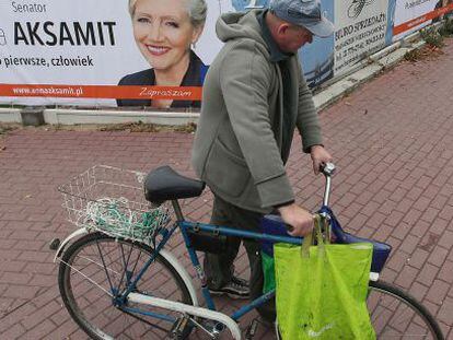 Un hombre pasa frente a un cartel electoral, el 14 de octubre, en Varsovia. 