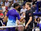 Novak Djokovic, of Serbia, left, greets Jenson Brooksby, of the United States, after beating Brooksby during the fourth round of the U.S. Open tennis championships, Monday, Sept. 6, 2021, in New York. (AP Photo/John Minchillo)