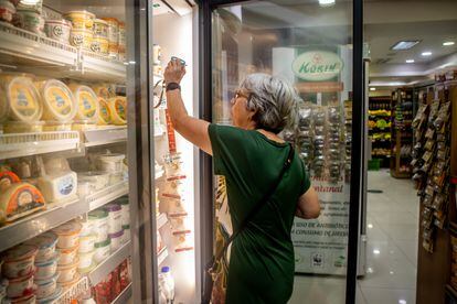 A woman chooses refrigerated products at a Korin store. 