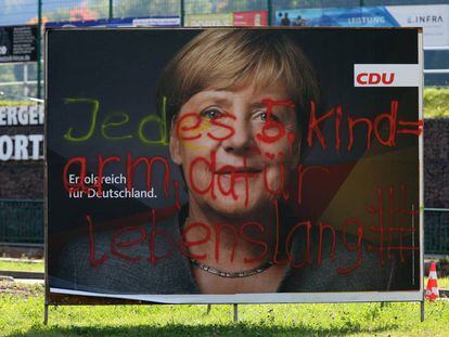 Pintada antiinmigrantes en un cartel electoral de Angela Merkel.