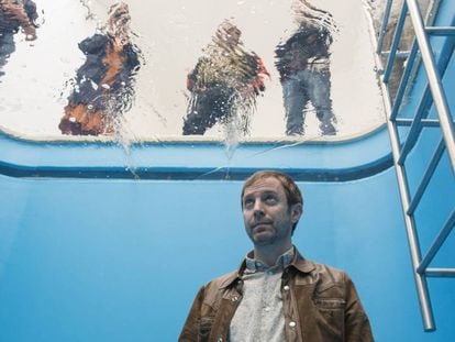Leandro Erlich posa dentro de su obra 'Swimming pool/Pileta', exhibida en el Malba.