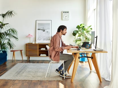 Freelancer Writing In Book At Home Office