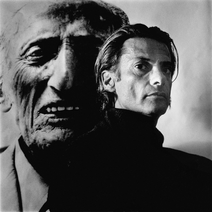 Avedon, in front of one of the photos he took of his father.