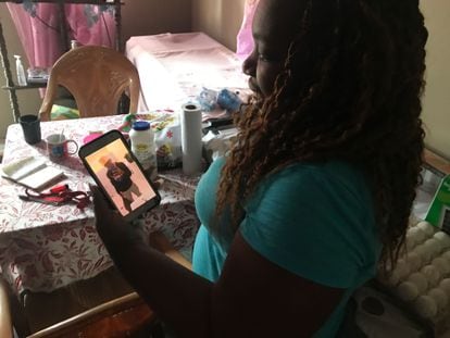 Vilma shows a photo of her son who went to the United States.  In the living room of his house, he keeps the gas stoves that the municipal government gave him.