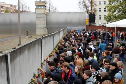 "El muro de Berlín es historia y nos enseña que, ningún muro es tan alto o tan ancho que no se pueda atravesar", ha sentenciado Merkel este sábado. En la imagen, una multitud de personas visita el Memorial del Muro de Berlín durante los actos del 30º aniversario de su caída.