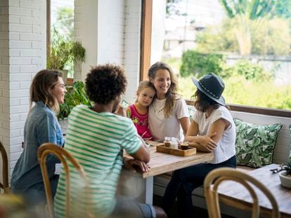 Un grupo de amigos y una niña en una cafetería.