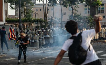 Manifestantes arrojan piedras a la policía que reprime con perdigones y gases lacrimógenos, en Lima, el 19 de enero de 2023. 