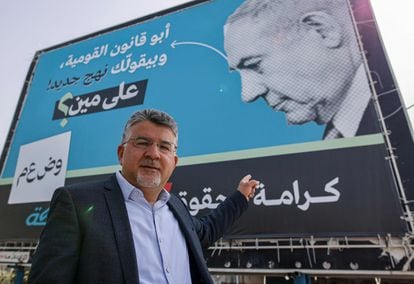 El diputado árabe Yosef Yabarin ante un cartel contra Netanyahu en Um el Fahm, que le denomina "padre del Estado nación Judío".