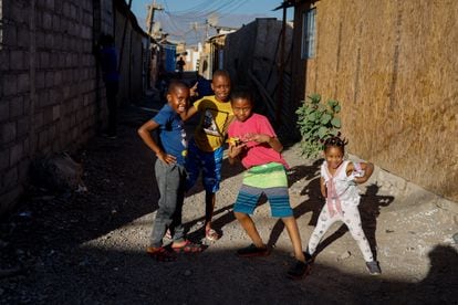 A group of Haitian children play in the streets of the Nuevo Amanecer de Cerrillos camp, in Santiago de Chile, where more than 2,000 families and nearly 10,000 people live.