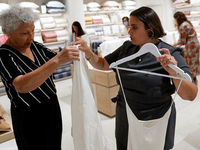 Una dependienta de Zara Home ayuda a una clienta en una tienda de San Sebastián de los Reyes (Madrid) que acaba de poner en marcha un programa de empleo para integrar a personas con discapacidad.