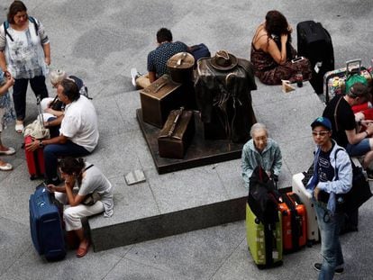 Una decena de viajeros espera en la estación de Atocha de Madrid. 