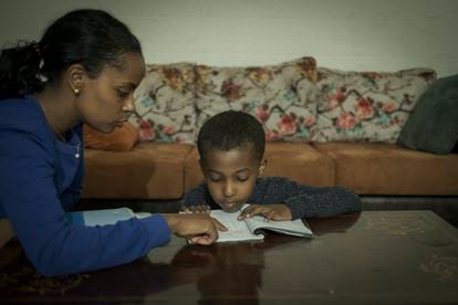 Rahim Teshome ayuda a su hijo, de seis años, a realizar las actividades escolares en el interior de su casa. “Tengo mucho miedo por él, pero debo garantizarle un lugar seguro. Si aquí el Estado no se hace cargo por el sistema de la kafala implantado, tendremos que buscar alguna solución”.