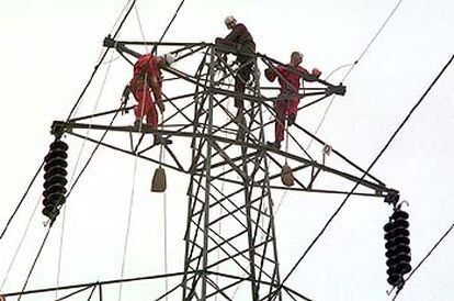 Operarios de una compañía eléctrica arreglan la red