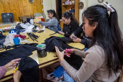 Young people work on making clothing, in one of the CASA workshops, on September 2.