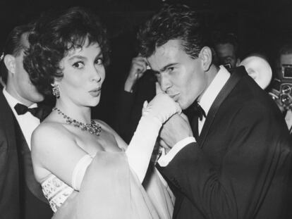 FILE - German actor Horst Buchholz kisses the hand of Italian actress Gina Lollobrigida, during the International Film Festival (Berlinale) in Berlin, Germany, July 5, 1958. (AP Photo/Werner Kreusch, File) Lollobrigida has died in Rome at age 95. Italian news agency Lapresse reported Lollobrigida’s death on Monday, Jan. 16, 2023 quoting Tuscany Gov. Eugenio Giani. (AP Photo/Werner Kreusch, File)