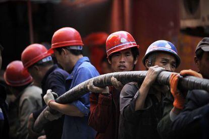 Trabajadores chinos en Pek&iacute;n. 