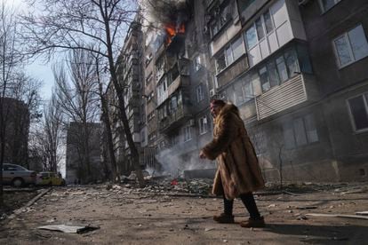 A woman in front of burning buildings in Mariupol, on March 13.