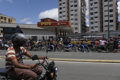 A line of motorcyclists wait to refuel at a gas station in Caracas, in August 2020.