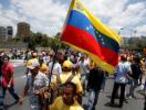 Opposition supporters holding a Venezuelan flag protest against Venezuela's President Nicolas Maduro's government during a rally in Caracas