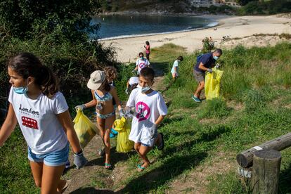 Voluntarios de la pasada edición de '1m2 por las playas y mares' recogen residuos en la playa de Limens (Pontevedra).
